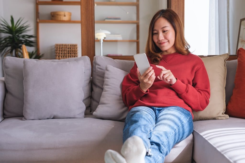 A guest at home choosing a dish on her phone to collect later